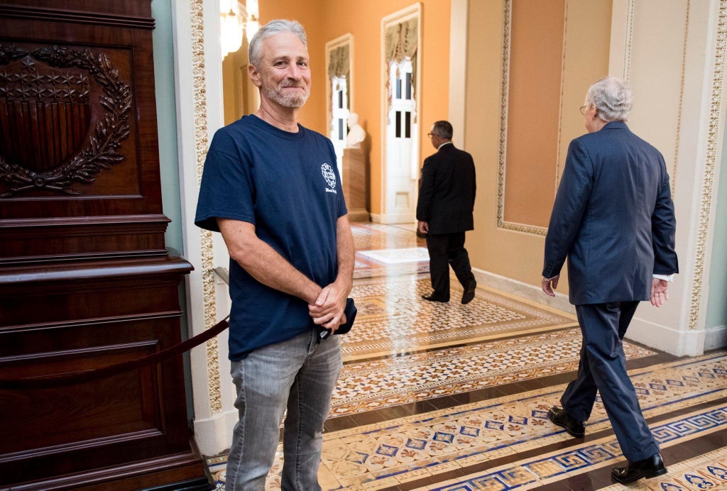 Jon Stewart smiling with bitch turtle in background